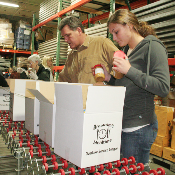 Volunteers pack Breaktime-Mealtime boxes.