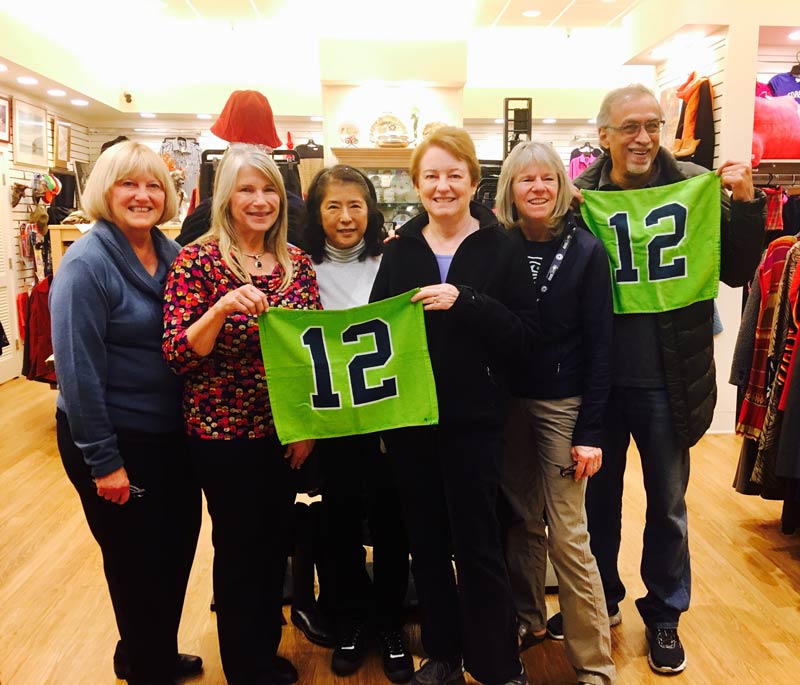 Thrift Culture volunteers with the 12th Man Flag